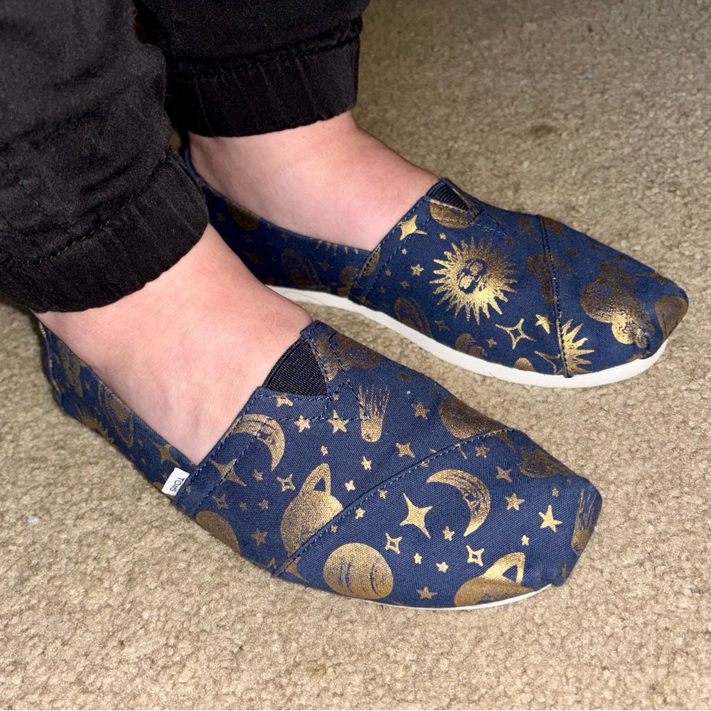 Toms women’s Blue and Gold Celestial Slip-Ons